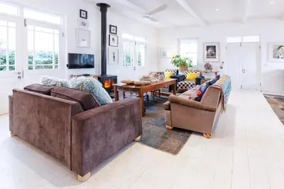 a large living room with two couches and a table at The Vishuis in Hermanus
