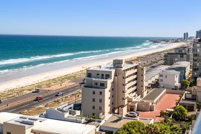 an aerial view of the beach and buildings at The Waves 1002 in Bloubergstrand