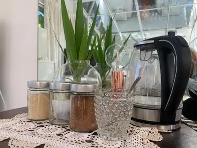 a table with a coffee maker and jars of spices at The Little Hideaway Guesthouse in Stellenbosch