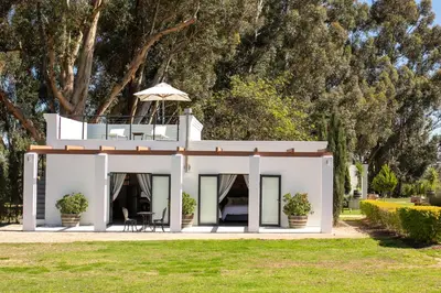 a house with a balcony on top of it at Rest at Chabivin in Stellenbosch