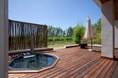 a wooden deck with an umbrella and an umbrella at Rest at Chabivin in Stellenbosch