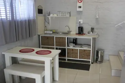a small kitchen with a table and a sink at 25 on Fitzpatrick in Parow