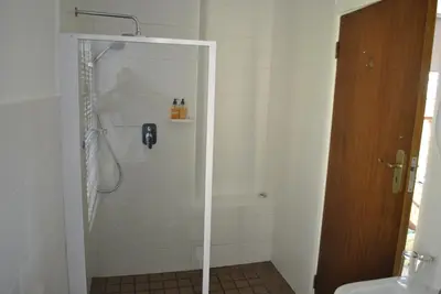 a bathroom with a shower and a toilet at Cotswold House in Cape Town