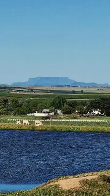 a large body of water with rocks in the middle at Rooiheuwel Cottage in Wellington
