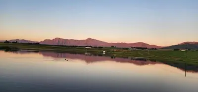 a body of water with mountains in the background at Rooiheuwel Cottage in Wellington