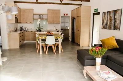 a living room and kitchen with a couch and a table at Lavinia Lifestyle in Stellenbosch
