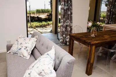 a living room with a couch and a wooden table at Lavinia Lifestyle in Stellenbosch