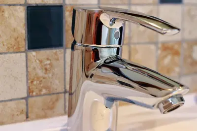 a bathroom sink with a chrome faucet at Milas Place in Somerset West