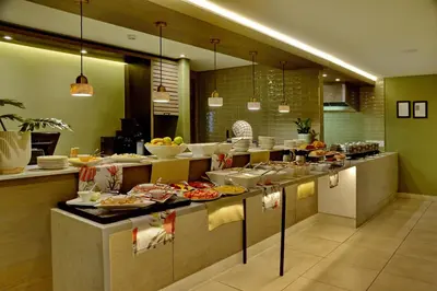 a large kitchen with many plates of food at Town Lodge Bellville in Bellville