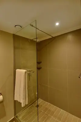 a bathroom with a shower with a glass door at Town Lodge Bellville in Bellville