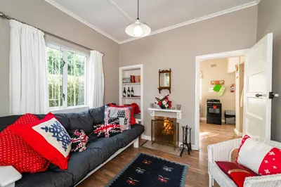 a living room with a couch and a fireplace at Belfield Wines and Farm Cottages in Grabouw