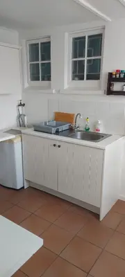 a kitchen with a sink and a counter top at Rose Cottage in Hermanus