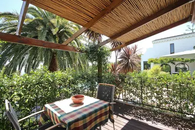a table with a bowl on it on a patio at Montrose Guesthouse in Somerset West