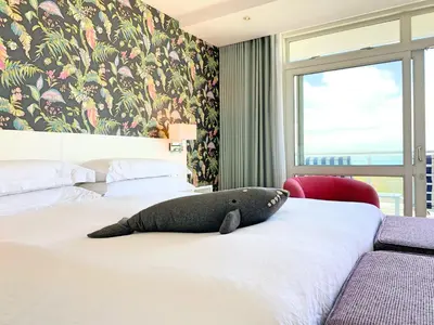 a bedroom with a stuffed whale on a bed at One Marine Drive Boutique Hotel & Spa by The Living Journey Collection in Hermanus