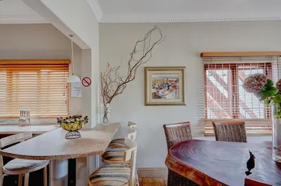 a kitchen with a table and chairs and a dining room at Beautiful Abalone in Hermanus