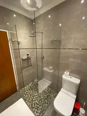 a bathroom with a glass shower with a toilet at Beautiful Abalone in Hermanus