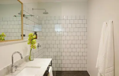 a white bathroom with a sink and a mirror at Twice Central Guest House in Stellenbosch