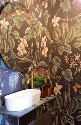 a bathroom with a sink and a floral wallpaper at Twice Central Guest House in Stellenbosch