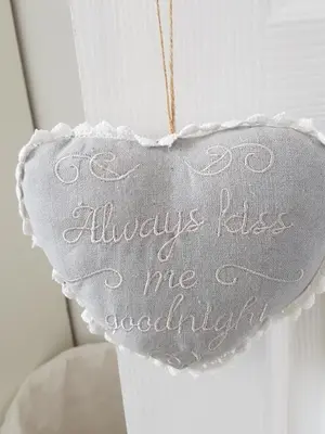 a white heart hanging on a door at Stukkie Cottage in Hermanus