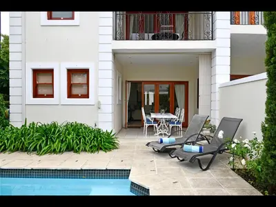 a house with a pool and a table and chairs at 10 Villefranche in Franschhoek