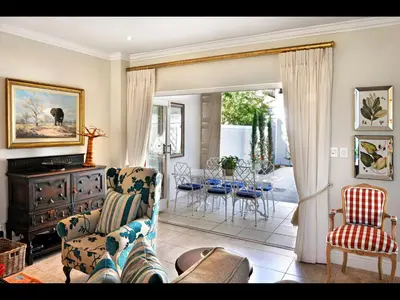 a living room with a couch and chairs and a table at 10 Villefranche in Franschhoek