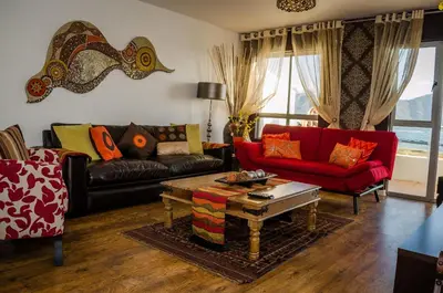 a living room with two couches and a coffee table at Greenways Emerald Bay in Strand