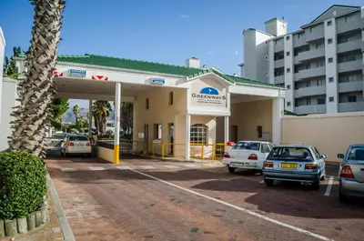 a gas station with cars parked in front of it at Greenways Emerald Bay in Strand