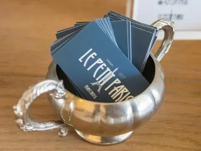 a metal tea cup filled with packets of tea at Le Petit Paris in Franschhoek