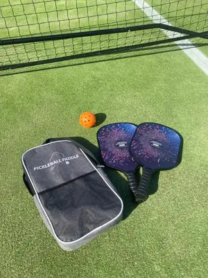 a pair of mitts sitting on a tennis court at Strand Beach Lodge in Strand