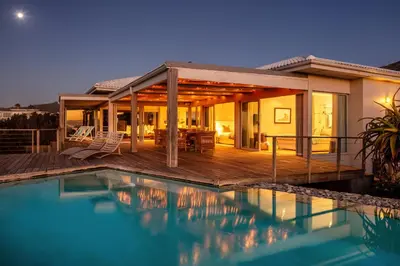 a house with a swimming pool and a deck at Pringle Bay Villa in Pringle Bay