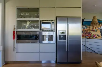 a kitchen with a stainless steel refrigerator and appliances at Pringle Bay Villa in Pringle Bay