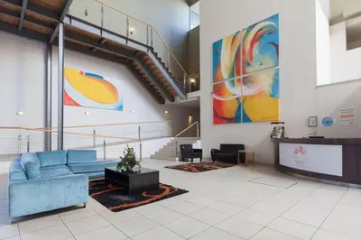a lobby with a blue couch in a building at Lagoon Beach 136A by CTHA in Cape Town
