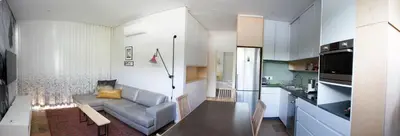 a living room with a couch and a kitchen at Laanhof Studios in Stellenbosch
