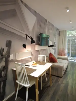 a living room with a table and a couch at Laanhof Studios in Stellenbosch