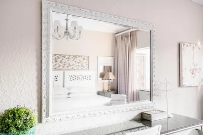 a large mirror in a bedroom with a bed at Avemore Vredehof No 2 - full Backup Power in Stellenbosch