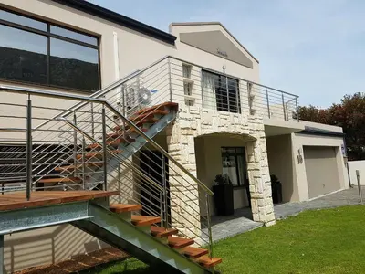 a house with a spiral staircase in front of it at Seaside Hermanus Guest Room in Hermanus