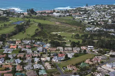 an aerial view of a town with houses and the ocean at Seaside Hermanus Guest Room in Hermanus