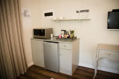 a small kitchen with a microwave and a counter at Afrika-Pearl in Paarl