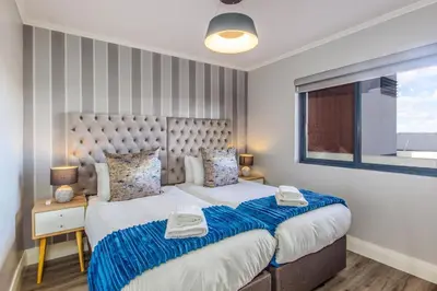a bedroom with a large bed and a window at Quayside 301 by CTHA in Cape Town