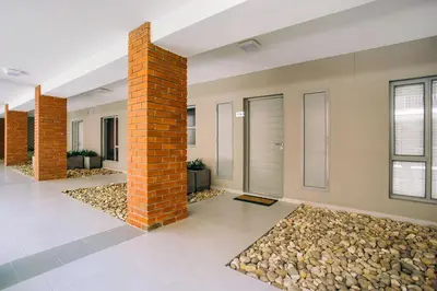 a room with a brick pillar and a pile of rocks at Superior Apartment Mayfair in Cape Town