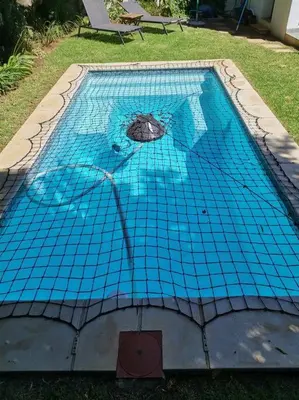 a blue tiled swimming pool in a yard at Anesta House in Stellenbosch