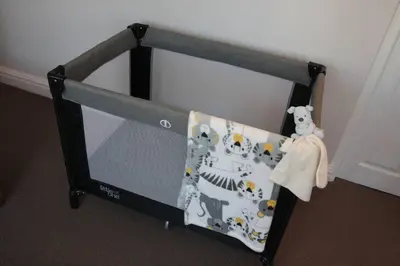 a crib with a tv in the corner of a room at Anesta House in Stellenbosch