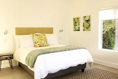 a bedroom with a bed and a window at Hermanus Champagne Accommodation in Hermanus