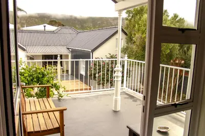a balcony with a view of a house at Hermanus Champagne Accommodation in Hermanus