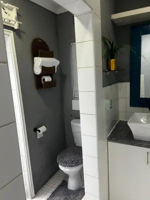 a bathroom with a toilet and a sink at Mitchell's Guesthouse in Parow
