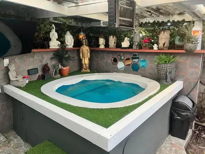 a large bath tub with a blue water in it at Mitchell's Guesthouse in Parow