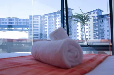 a roll of toilet paper sitting on top of a bed at Manhattan Luxury Suite at Canal Walk in Cape Town