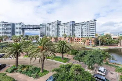 a view of a city with palm trees and buildings at Manhattan Luxury Suite at Canal Walk in Cape Town