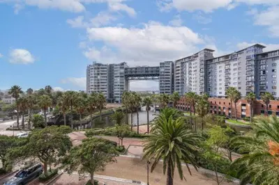 a large city with tall buildings and palm trees at Manhattan Luxury Suite at Canal Walk in Cape Town