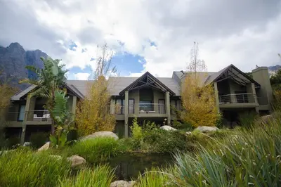 an exterior view of a house with mountains in the background at Du Kloof Lodge in Paarl